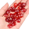 Vibrant red carnelian flower-shaped loose beads held in hand for DIY jewelry making - Small Cat Head (1 Piece)