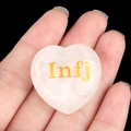Heart-shaped pink rose quartz stone featuring a golden INFJ MBTI personality engraving - Advocate/Infj