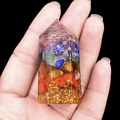 Handmade hexagonal orgone tower with layered crystals and copper coil on black background - Rainbow Stone