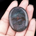 Polished natural bloodstone worry stone with unique red spots in a smooth oval shape - India Agate