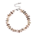 Smoky quartz beaded bracelet with irregular stones and golden metal cylindrical spacers - Black Super Seven