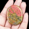 Polished Unakite oval worry stone with natural green and salmon pink speckled textures - Unakite