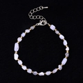 Irregular blue stone bracelet with gold beads and lobster clasp on black background - Purple Agate