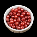 Polished dark red agate loose round beads with center holes in a ceramic bowl - 6mm-2mm Red Agate
