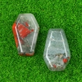 Polished natural crystal mini coffin figurines with red and green inclusions on green grass - African Blood Stone