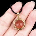 Ethnic style gold star pendant with shimmering reddish brown goldstone on black cord - Goldstone (Synthetic) (Gold)