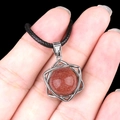 Silver hexagram pendant with brown goldstone and black cord shown in hand - Green Aventurine (Silver)