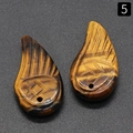 Tiger Eye stone pendant pair with carved wing patterns and natural cat eye chatoyancy - Tiger's Eye