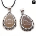 Vintage teardrop-shaped brown agate pendant with ornate silver-toned filigree frame - Grey Agate