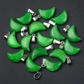 Vibrant emerald green agate moon pendants set with silver metal bails on black background - Malay Jade