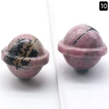 Mini planet-shaped natural pink rhodonite crystal carving with orbital rings - Rhodonite
