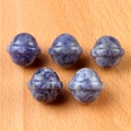 Five blue natural sodalite gemstone beads in planet shape on light wood surface - Sodalite