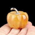 Handheld view of orange crystal quartz pumpkin stone with silver metal stem detail - Yellow Jade (1445) / 30mm