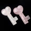 Two natural rose quartz crystal carvings in heart key shape with pink mineral textures - Rose Quartz