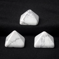Three white turquoise pyramids with grey marble textures on black fabric surface - 14mm / Howlite