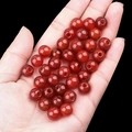 Deep red carnelian agate round beads with large hole held in hand for DIY jewelry - 10mm Diameter 3mm Hole