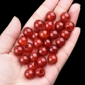 Translucent red agate large hole beads held in hand for DIY jewelry making - 12mm Diameter 5mm Hole