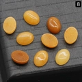 Set of nine oval orange natural crystal gemstones for DIY jewelry ring making - Yellow Jade