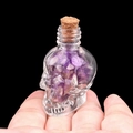 Skull shaped glass bottle filled with purple amethyst stones and natural cork stopper - Amethyst