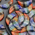 Polished crescent moon chakra stones in vibrant rainbow layers for home decor - Rainbow Moon Style