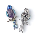 Parrot brooch pendant with purple gemstone and blue enamel wings on a silver base - Amethyst