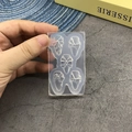 Detail of transparent silicone nail art mold showing five different 3D bow shapes - 121-Bow-knot