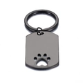 Llavero rectangular de acero negro mate con diseño de huella de animal calada - Negro