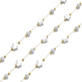 Close-up of 18k gold chain with shell stars and translucent blue circular beads - Flower