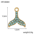 Close-up of golden whale tail pendant with light blue rhinestones for jewelry making - Light Blue Fish Tail Pendant (HP3386B4)