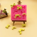 Rosa Silikonform für Schleifen mit verschiedenen Formen und gelber Kuchendekoration aus Fondant - 8-Loch Schleife