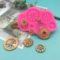 Pink silicone mold for punk gears crafts with golden gear decorations on a blue background - Hot Pink