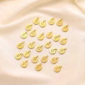 Set of 26 gold 14K round pendants with diamond-set letters A-Z on fabric background - Gold / Set of 26