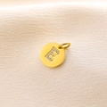Polished 14K gold-plated round pendant featuring letter E with micro-pave crystals - Letter E
