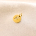 14K gold-plated round letter F pendant with micro-pave diamond accents on silk fabric - Letter F