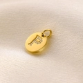 14K gold-plated oval pendant with pave-set diamond letter P on white silk background - Letter P