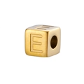 Macro view of a 14K gold-plated stainless steel cube bead with an engraved letter E - Gold E