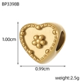 Macro view of gold heart bead with floral relief and hole detail for jewelry making - Heart Shape with Embossed Flower (BP3398B)