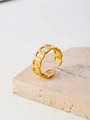 Detail view of a gold chain link ring with adjustable open band on stone texture - Chain Link Style (FJ34575D0W0)