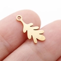 Golden stainless steel leaf pendant for DIY jewelry, shown held by fingers for scale - Leaf Shape (DY762-2) / Gold