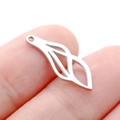 Minimalist silver stainless steel hollow leaf pendant shown on fingertip for scale - Steel Color Linear Leaf (DY756-1)