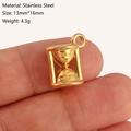 Golden hourglass-shaped stainless steel pendant charm shown in hand, size 13x16mm - Hourglass Style (DY1201-2) Gold