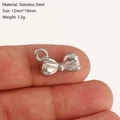 Polished silver stainless steel bow pendant measuring 12x18mm on a fingertip - Bow-knot Style (DY1202-1) Silver