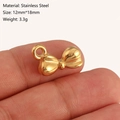 Golden stainless steel bowknot pendant 12x18mm charm shown on finger for scale - Bow-knot Style (DY1202-2) Gold