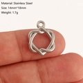 Silver stainless steel heart knot pendant shown held between fingers, 14mm by 18mm size - Heart Knot Style (DY1205-1) Silver