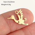 Golden stork bird charm pendant for DIY jewelry making shown on a fingertip for size - Gold Stork (DY1310-2)