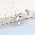 Macro shot of silver stainless steel cross pendant featuring hollowed JESUS lettering detail - JESUS Letter Hollow Style (Steel Color) / Steel