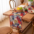 Tropical rainforest jacquard table runner with colorful tassels on a dark wood dining table - 35x140cm / Red Tropical + Red Tassel