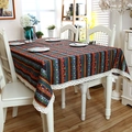 Detail of bohemian striped tablecloth with white lace edges on a wooden table - Red Blue Gold (With Lace)