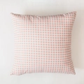Close-up of pink and white gingham pattern fabric texture on a square cushion cover - Pink Plaid