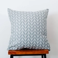 Close-up of a grey and white herringbone pillow on a minimalist wooden bench - Grey Geometric
